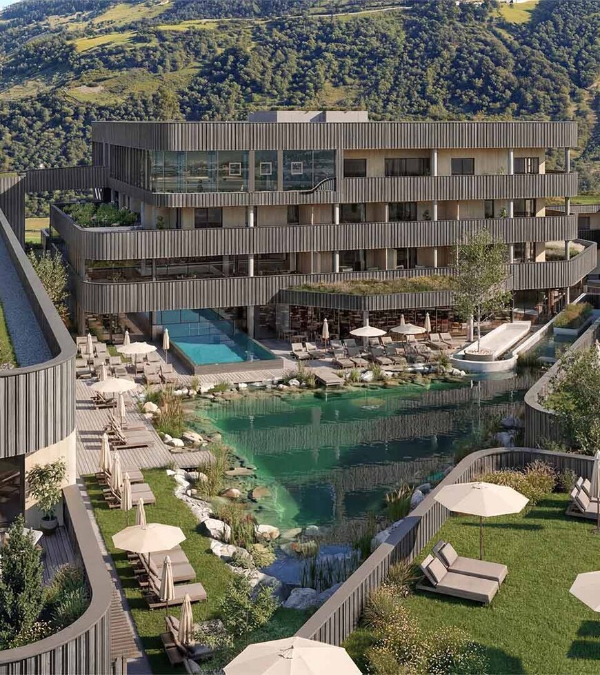 TheGreen-Visualisierung-Aussenaufnahme-1 Mehrstöckiges modernes Hotelgebäude mit Holzfassade vor bewaldeten Berg und einem natürlichen Schwimmteich mit Liegestühlen und Sonnenschirmen auf einer Wiese