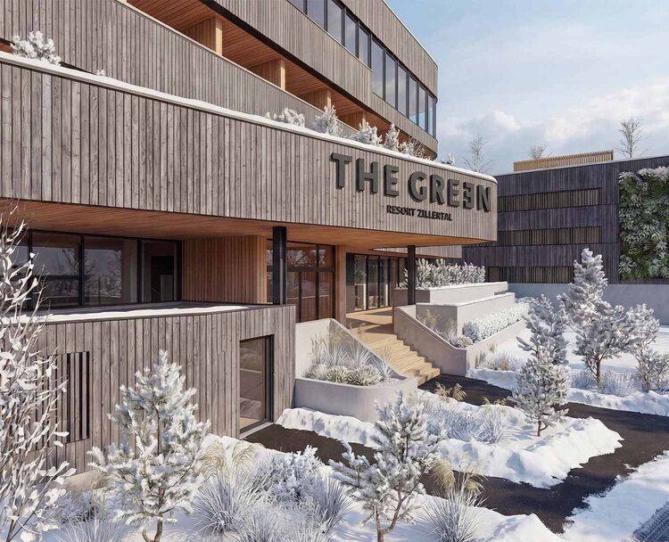TheGreen-Visualisierung-Aussenaufnahme-Winter-2 Holzfassade eines modernen Gebäudes mit dem Schriftzug 'THE GREEN' und schneebedeckten Bäumen und Wegen im Vordergrund