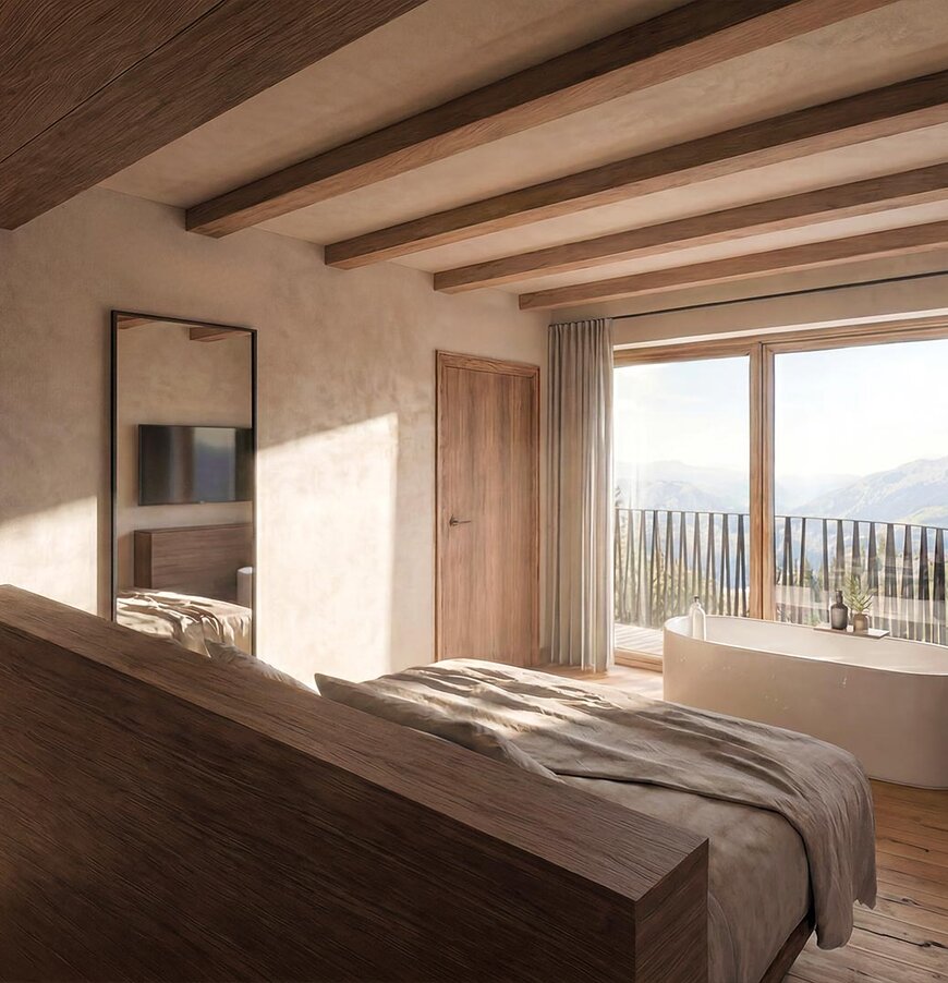 thegreen-zimmer-watersuites-2 Schlafzimmer mit großem Bett, Holzwänden und -boden, Zugang zu Balkon mit Sitzmöbeln